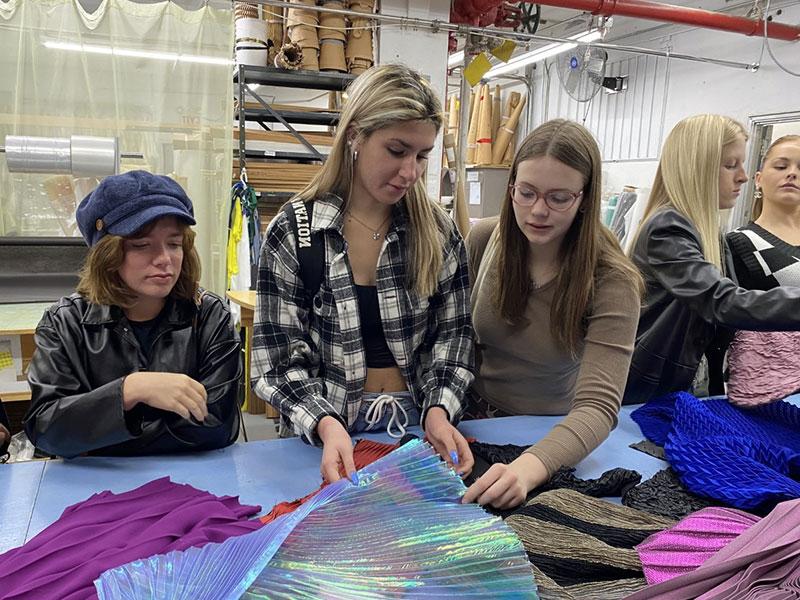 Fashion students looking at fabrics